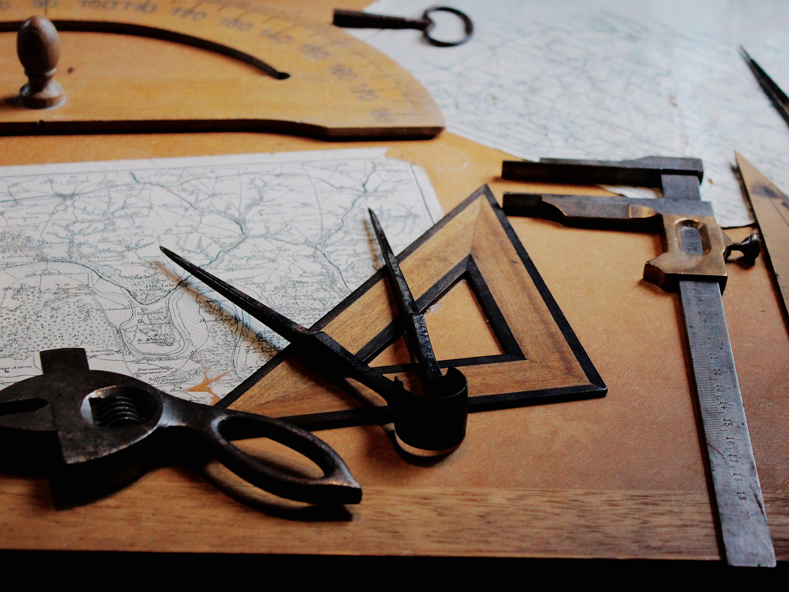 Drafting tools and equipment lie on a workspace.